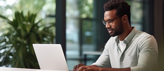 Close up of smiling African American freelancer typing on laptop enjoying remote job