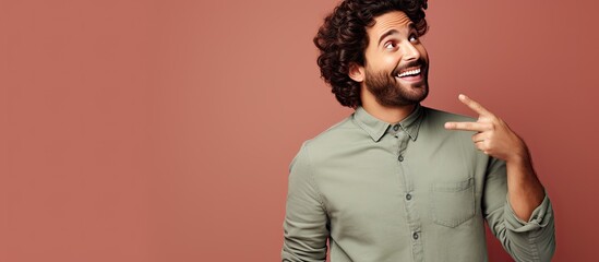 Poster - Young man with a great idea pointing to lateral copy space looks happy and surprised