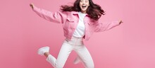 Asian Woman Happily Jumping And Smiling While Turning Her Head Back On Pink Background
