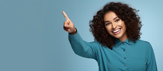 Poster - Happy Hispanic woman pointing enthusiastically with both hands showcasing an object in the available space