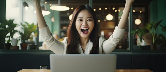 Poster - Asian woman celebrates at office with laptop showcasing success in startup