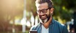 © HN Works - Bearded man using smartphone outdoors smiling making a call real person