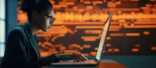Female IT developer typing on keyboard with programming code and laptop in office interior copy space available