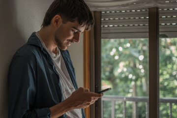 Canvas Print - teenager or young man at home with mobile phone or smartphone