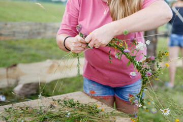 Childs lesson weaving wreaths of beautiful flowers