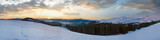 Fototapeta Niebo - Mountain ridge sunrise panorama view with moon and sun. Drahobrat Ski Resort, Yasenja villadge, Carpathians, Ukraine.
