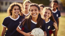 Teenager Girls Soccer Team Smiling Wearing Blue Kit And Holding A Ball On Soccer Field School Sport Physical Activity Fitness 