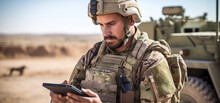 Soldier In Uniform Analyze Data On A Tablet And Work Out Tactics At A Temporary Base. Programming Control With Artificial Intelligence, Online Coordination Of The Military Team