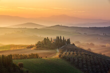 Beautiful Land House In Tuscany Italy With Beautiful Golden Sunset Lighting Up The Haze In The Background 