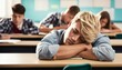 © ibreakstock - Bored blonde student sleeping at his desk in the classroom