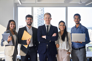 Wall Mural - Young happy professional international team business people workers standing in corporate office, diverse multiethnic smiling employees colleagues company staff posing for team portrait together.