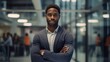 © brillianata - Young confident black man in front of a blurred modern office