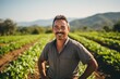 © NikoG - middle aged male mexican farmer smiling and working on a farm field portrait
