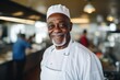 © Baba Images - Portrait of an african american chef working in a restaurant kitchen