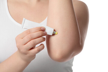 Poster - Woman applying ointment from tube onto her elbow on white background, closeup