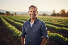Middle Aged Caucasian Farming Smiling On His Farm Field