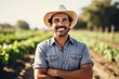 Middle aged latin male farmer working on a farm field smiling portrait