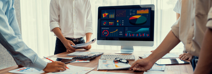 Leinwandbilder - Panorama shot analyst team utilizing BI Fintech to analyze financial report with laptop. Businesspeople analyzing BI power dashboard displayed on laptop screen for business insight. Scrutinize