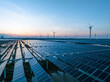 © zhu difeng - solar power panels and wind turbines on beach