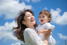 Cute Japanese Mother With Baby, Blue Sky Background. Created By Generative AI Technology.