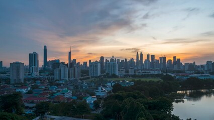 Wall Mural - Dramatic sunset scene time lapse at Kuala Lumpur city horizon, view from far distances. Pan right