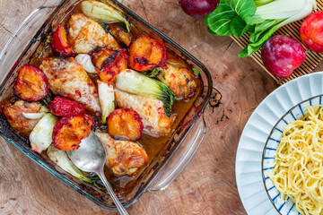 Canvas Print - Chicken drumsticks with plums and pak choi