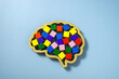 Neurodiversity concept. Brain shape and colorful wooden cubes.