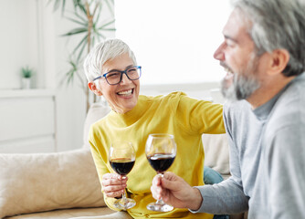 Wall Mural - love senior woman couple home wine glass celebration toast wineglass alcohol cheers holiday beverage red romantic anniversary dating toasting valentine eve portrait happy husband wife