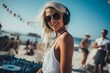© Dasha Yurk - Beautiful young woman dj blonde with long hair in headphones at a beach party, music and dancing. AI generated