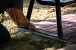 © fotodrobik - A construction worker bolts a park bench to paving stones.