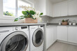 Spacious laundry room with washer dryer and neatly organized storage.