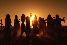 Group Of Hippies Dancing On The Beach At Sunset Time
