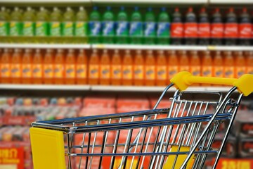 shopping cart in supermarket carbonated drink product background