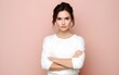© Vladislava - Portrait of a lovely angry young Caucasian girl wearing casual clothing standing isolated over pastel pink, purple, blue, yellow background, arms folded, ethnic, banner, jealous, AI Generated
