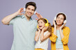 © ViDi Studio - Young fun satisfied parents mom dad with child kid daughter girl 6 years old wear blue yellow casual clothes listen to music in headphones dance isolated on plain purple background Family day concept