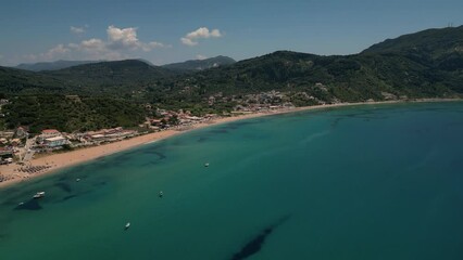 Wall Mural - Aerial drone footage capturing the beauty of Agios Georgios beach, with blue turquoise waters and sandy shore, with hills in the backdrop