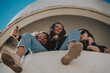 © qunica.com - Low angle view of three lovely girls with slight smile on their faces, looking at the camera