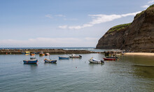 Commercial Fishing Boats Moored In Staithes Harbour On The North Yorkshire Coast