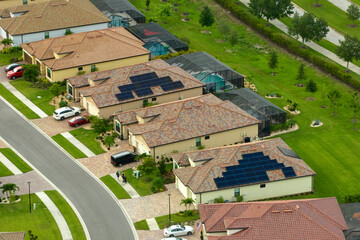 Wall Mural - Aerial view of tightly located family houses with solar panels on roofs in Florida closed suburban area. Real estate development in american suburbs