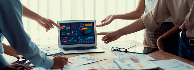 Leinwandbilder - Panorama shot analyst team utilizing BI Fintech to analyze financial report with laptop. Businesspeople analyzing BI power dashboard displayed on laptop screen for business insight. Scrutinize
