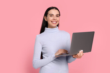 Poster - Happy woman with laptop on pink background