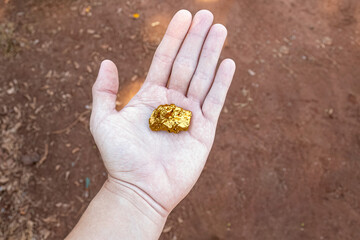 hand holding piece of gold