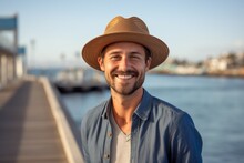 Portrait Of A Handsome Man Smiling While Standing On A Pier At Sunset