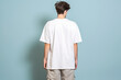 Back view of a man in a baggy white t-shirt isolated. Mockup concept.