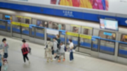 Wall Mural - out of focus blur top down view to passengers traveller walking on subway platform station after get