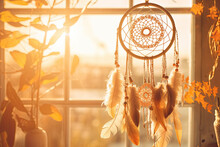 Dreamcatcher Hanging By A Window With The Soft Glow Of Golden Hour Sunlight 