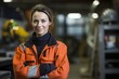 © igolaizola - Portrait of female industrial worker standing with arms crossed in factory warehouse