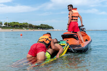 Lifeguards Rescue A Man In The Sea Using A Jet Ski