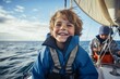 © igolaizola - Smiling boy on the deck of a sailing yacht in the sea