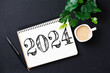 New year resolutions 2024 on desk. 2024 goals list with notebook, coffee cup, plant on wooden table. Resolutions, plan, goals, action, checklist, idea concept. New Year 2024 resolutions
